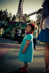 A little girl stares off into the distance in Children's Grand Park.